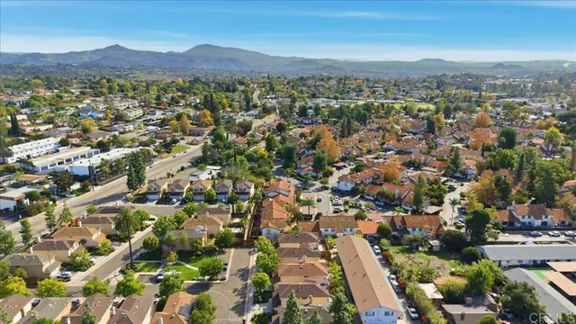 an aerial view of residential houses with city view