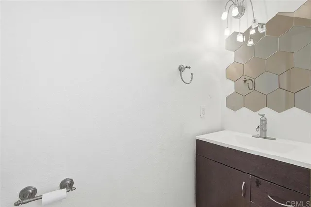 a bathroom with a sink vanity and a mirror