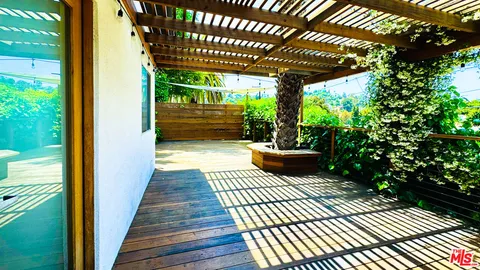 a view of a porch with wooden floor and fence