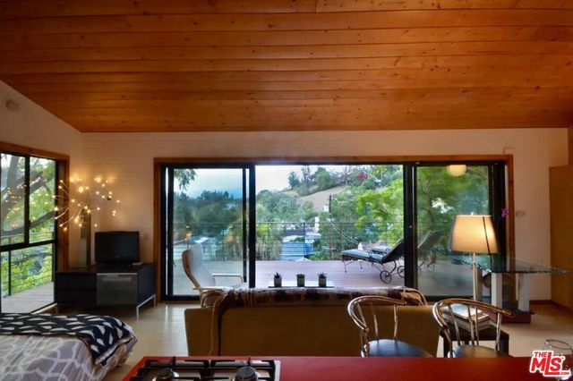a living room with furniture a window and a flat screen tv