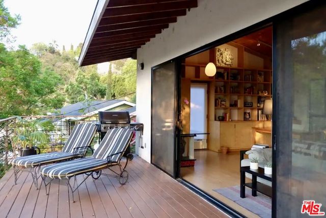a view of living room with porch and wooden floor