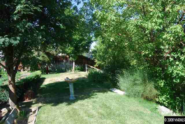 5210 Challis Circle Reno, NV 89523 - Photo 8 of 9 a view of a backyard with large trees