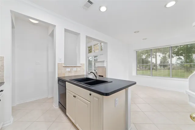 a kitchen with sink and cabinets