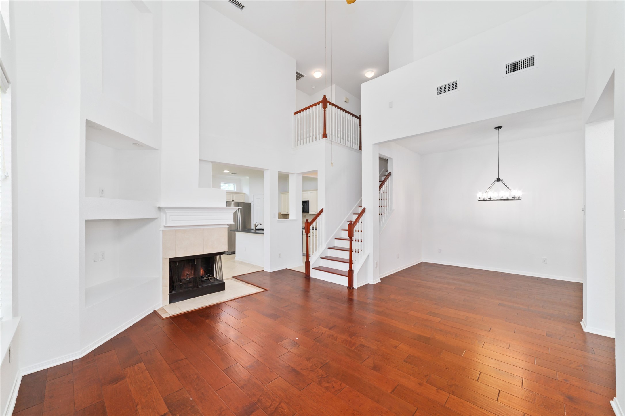 8030 Loyel Pointe Drive Houston, TX 77064 - Photo 5 of 27 a view of empty room with wooden floor and fireplace