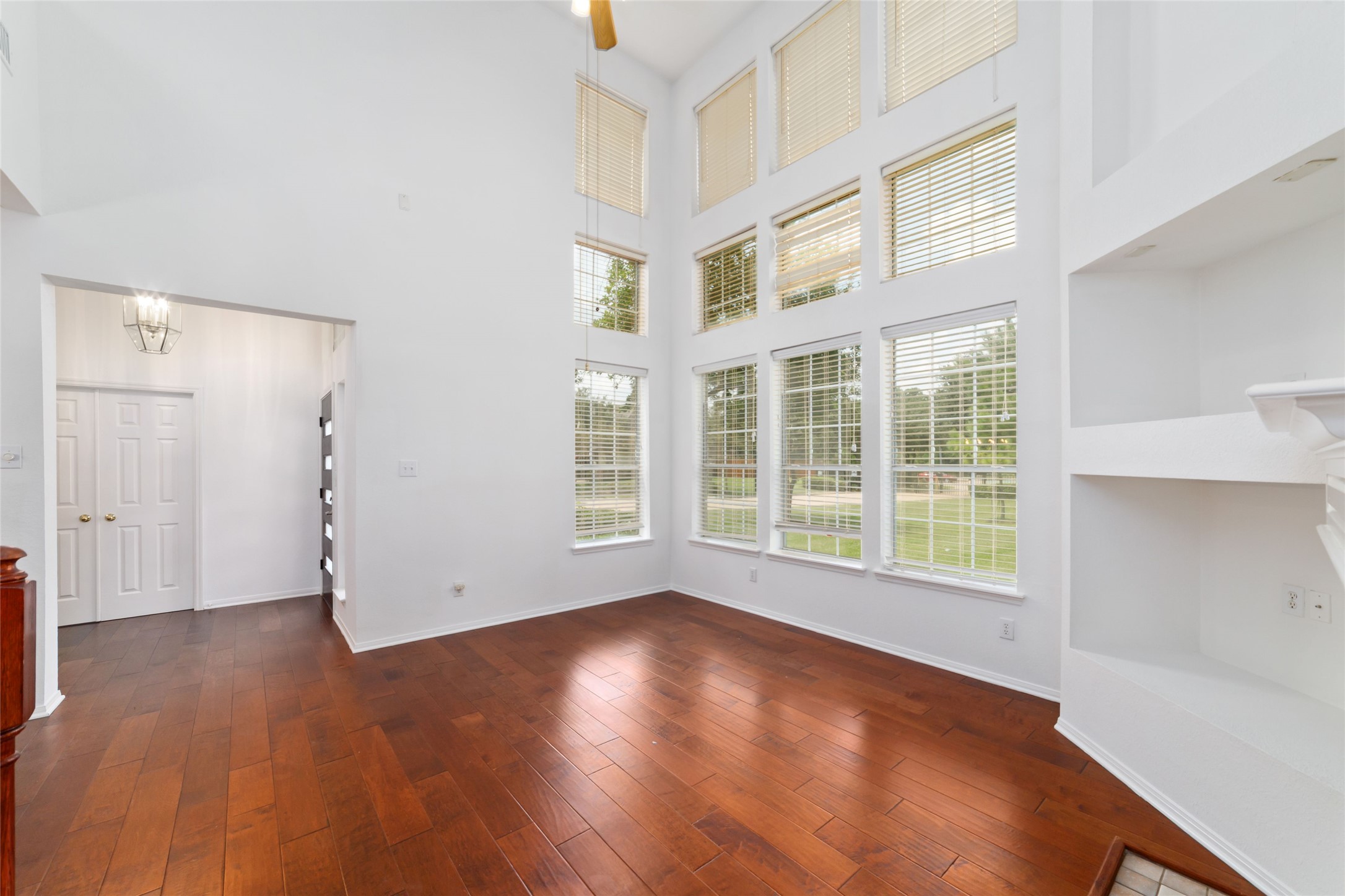 8030 Loyel Pointe Drive Houston, TX 77064 - Photo 7 of 27 an empty room with wooden floor and windows