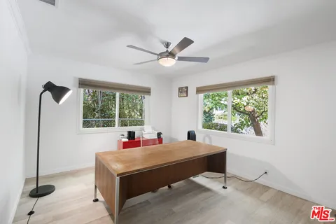 a living room with patio furniture and a large window