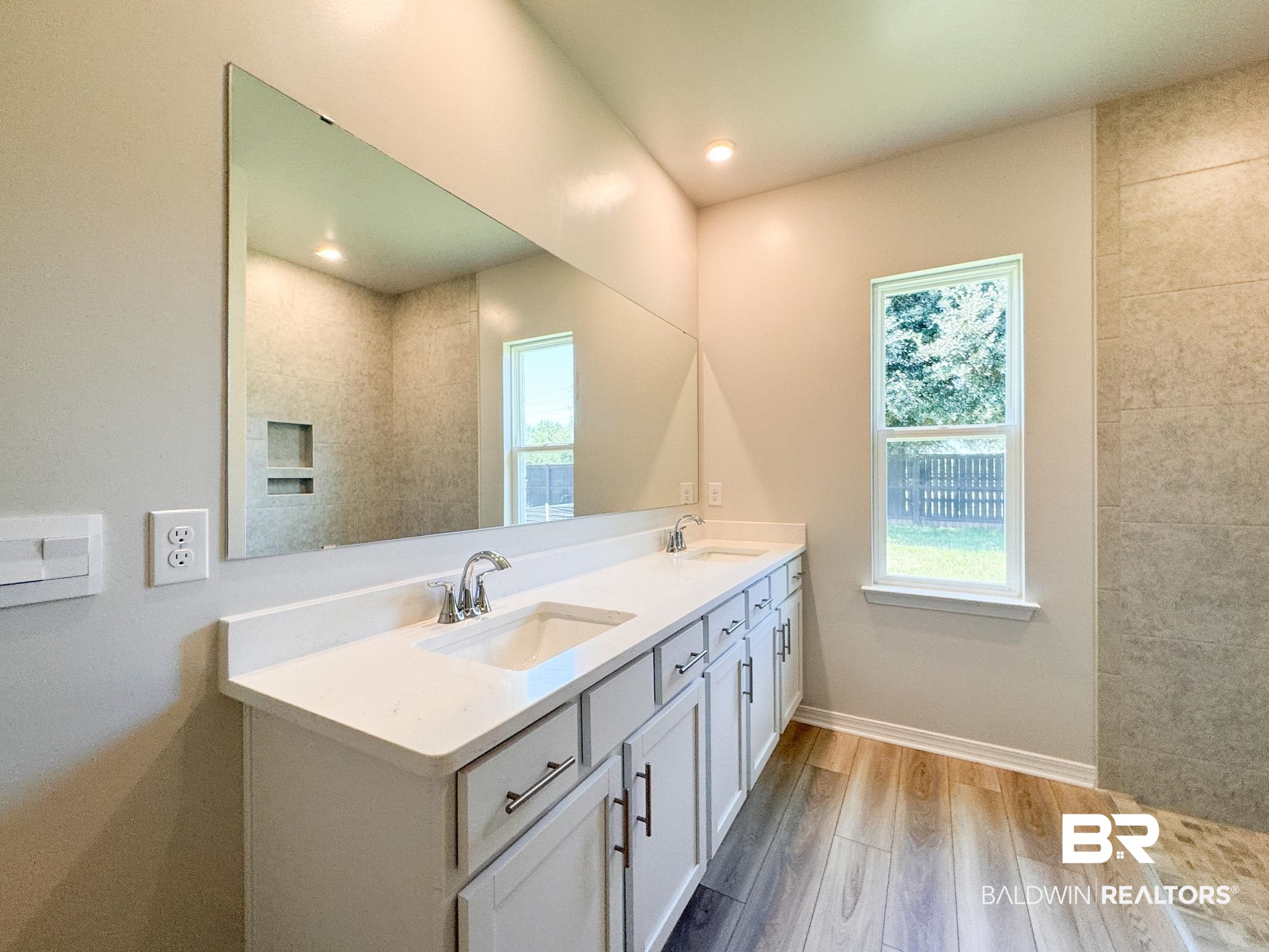 23939 Dominus Drive Daphne, AL 36526 - Photo 7 of 9 Full bath with light wood-style floors, double vanity, and plenty of natural light