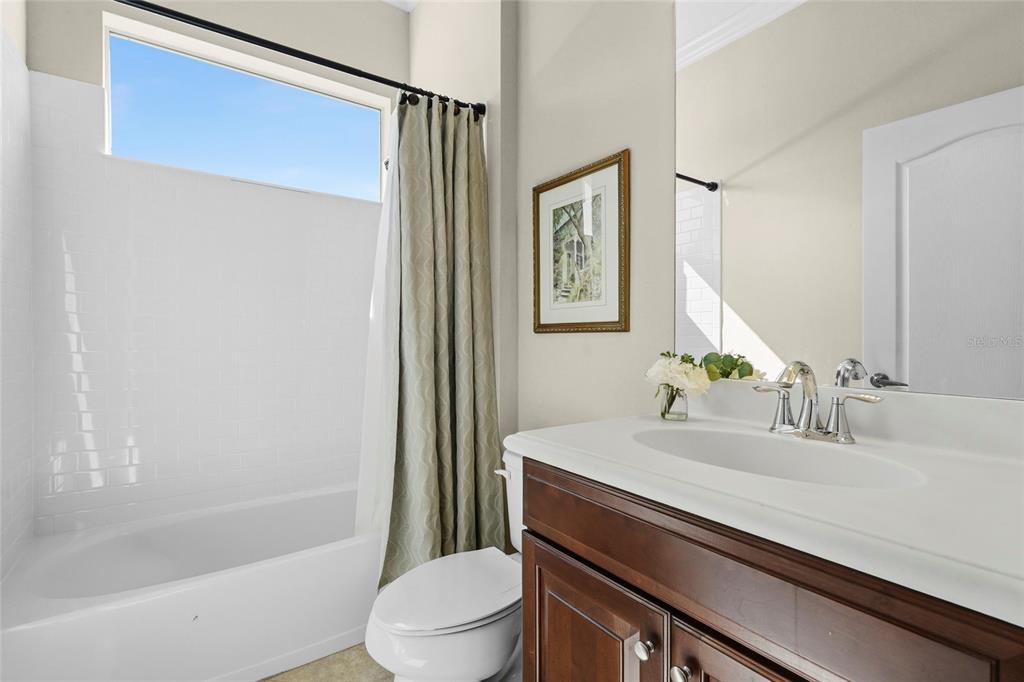 357 Marsh Creek Road Venice, FL 34292 - Photo 34 of 70 a bathroom with a sink a toilet a mirror and shower