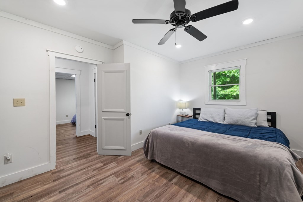 760 River Bend Lane Blue Ridge, GA 30513 - Photo 57 of 101 a bedroom with a bed and a chandelier