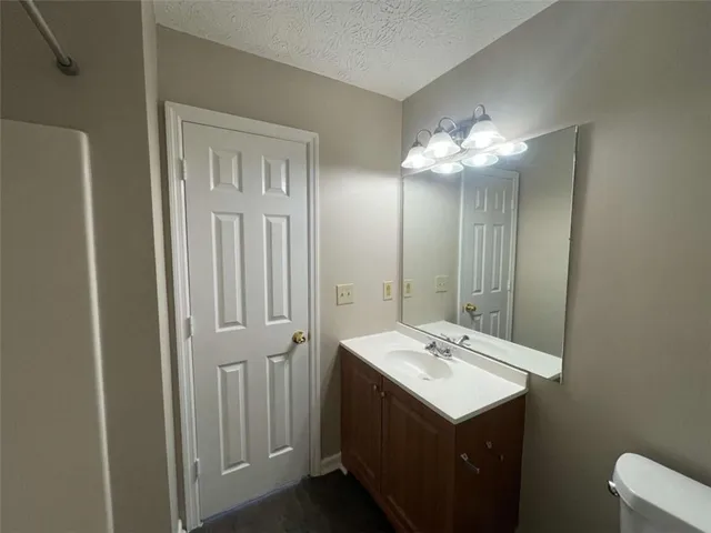 a bathroom with a sink vanity and mirror