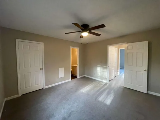 a view of a livingroom with a ceiling fan and window