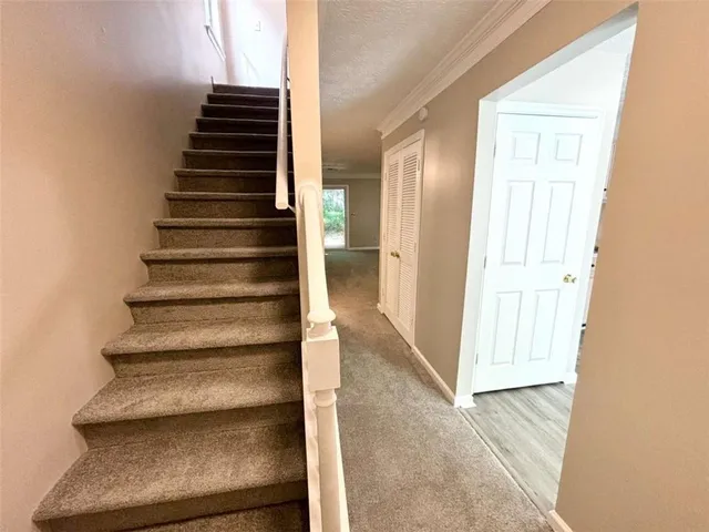 a view of entryway and hall with wooden floor