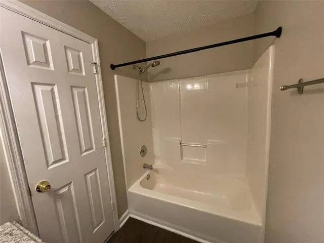 a bathroom with a shower and a bath tub