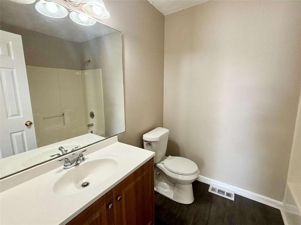 3774 Meadow Creek Drive, Unit 3774 Norcross, GA 30092 - Photo 28 of 29 a bathroom with a sink a toilet and a mirror