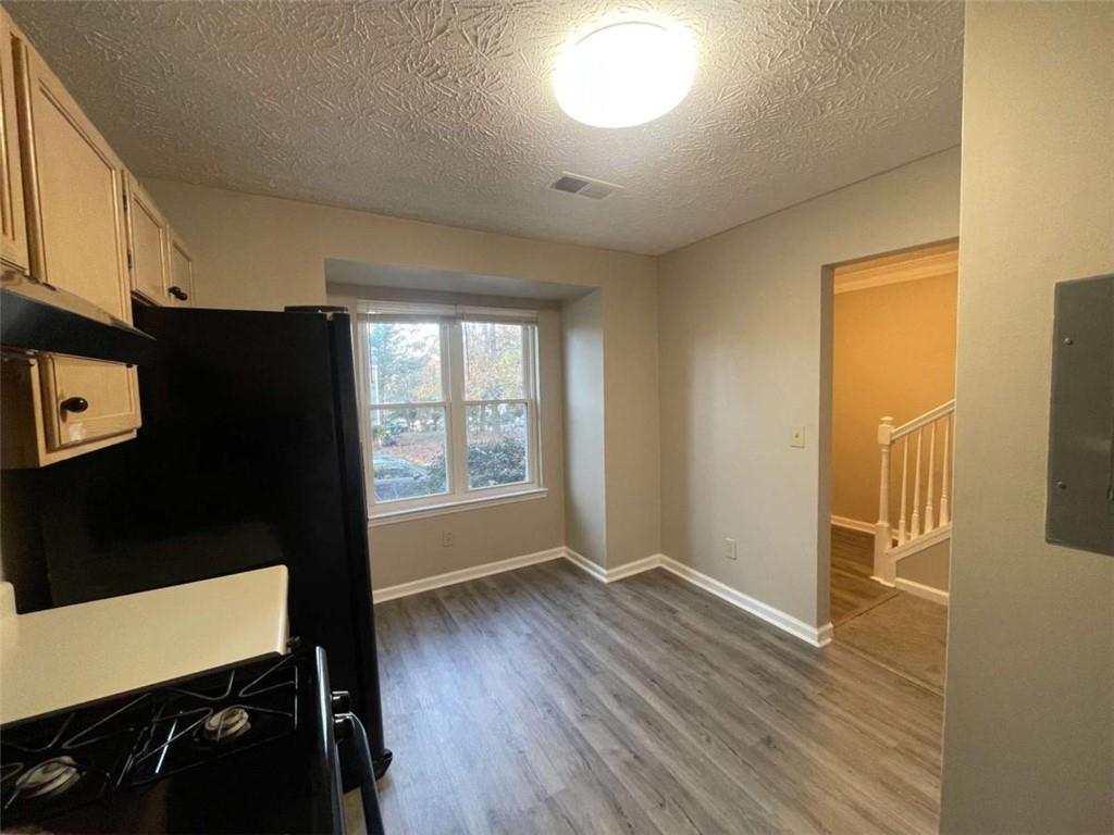 3774 Meadow Creek Drive, Unit 3774 Norcross, GA 30092 - Photo 7 of 29 a view of an empty room with a window and wooden floor