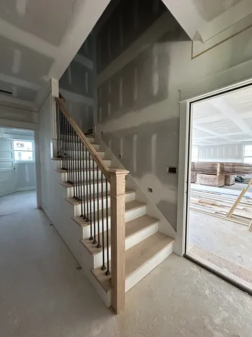 a view of a hallway with windows and stairs