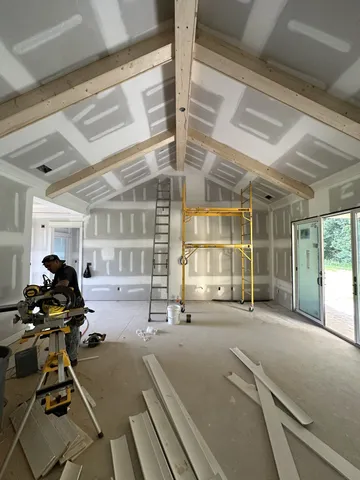 a spacious bedroom with a bed and a large window