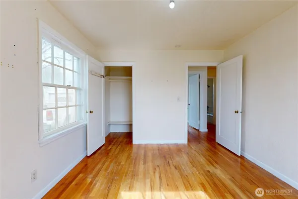 wooden floor in an empty room with a window
