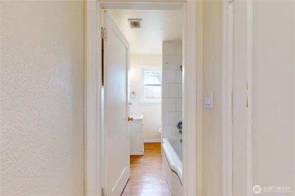 a view of a bathroom from a hallway