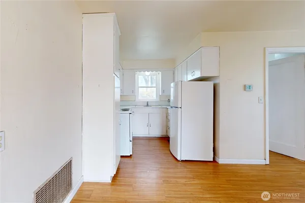 a view of a kitchen with wooden floor and a sink