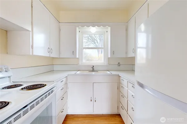 a kitchen with a sink stove and cabinets