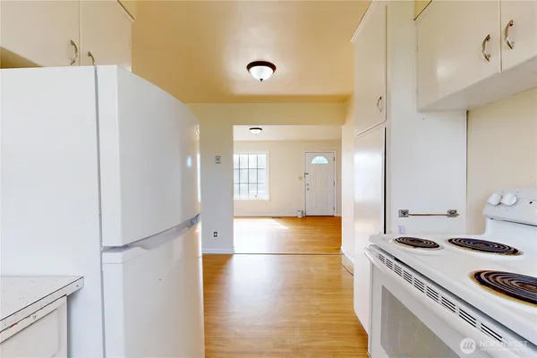 a kitchen with a refrigerator and a stove