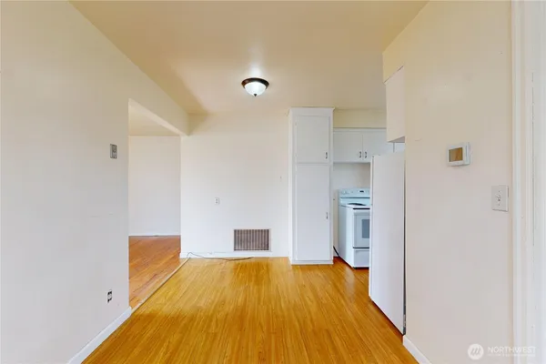 a spacious bathroom with a sink and a refrigerator