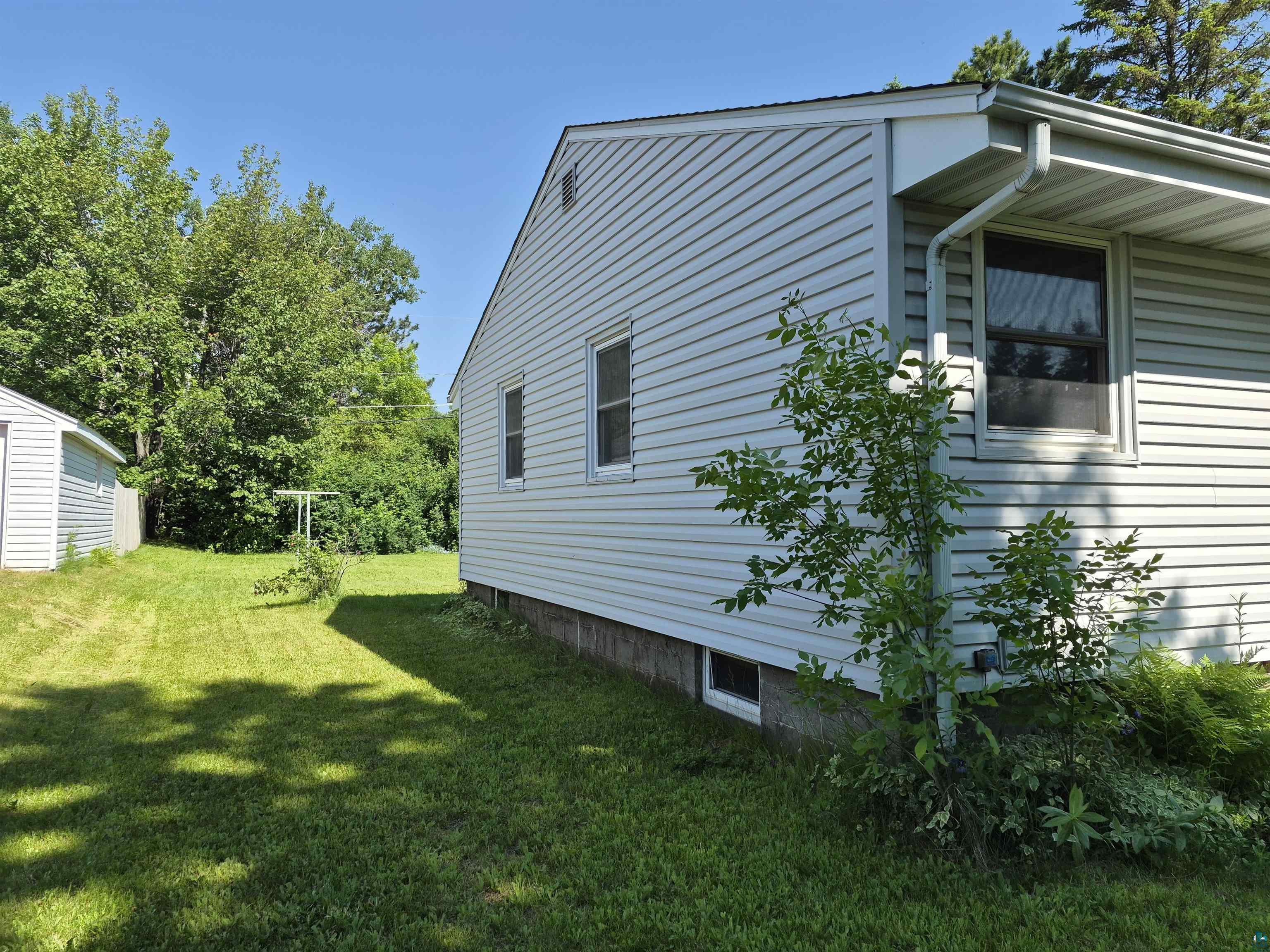 2109 West 22nd Street Duluth, MN 55811 - Photo 3 of 29 Exterior view featuring light-colored horizontal siding, white trim, and a gabled roofline