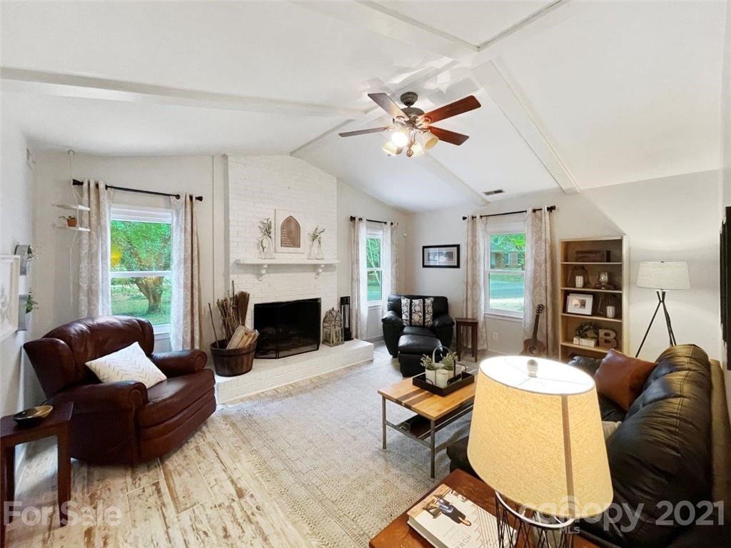 733 Neill Ridge Road Matthews, NC 28105 - Photo 12 of 30 a living room with furniture a fireplace and a window