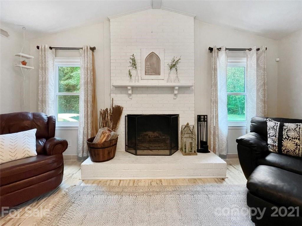 733 Neill Ridge Road Matthews, NC 28105 - Photo 13 of 30 a living room with furniture and a fireplace