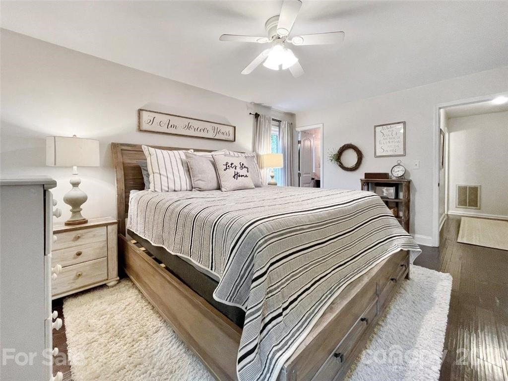 733 Neill Ridge Road Matthews, NC 28105 - Photo 18 of 30 a bedroom with a bed and a chandelier