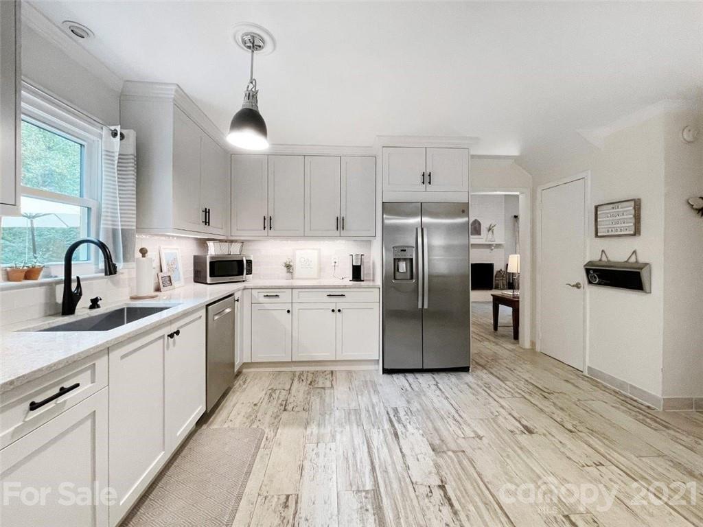 733 Neill Ridge Road Matthews, NC 28105 - Photo 8 of 30 a kitchen with a sink stainless steel appliances and white cabinets
