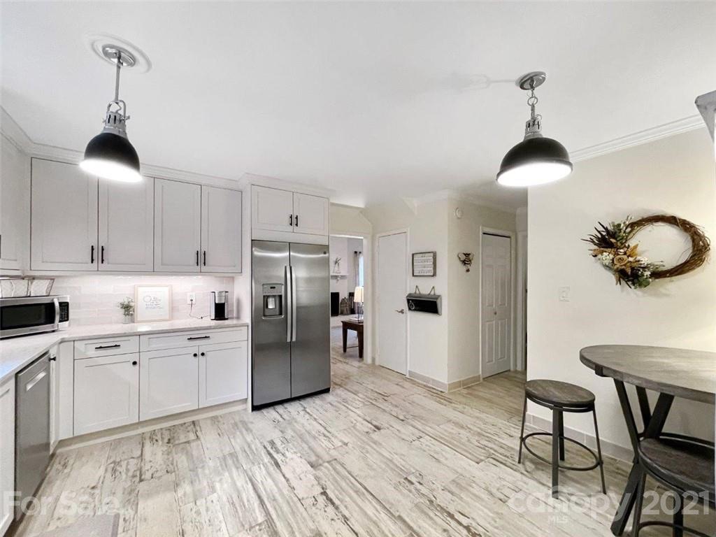 733 Neill Ridge Road Matthews, NC 28105 - Photo 10 of 30 a kitchen with stainless steel appliances a stove a refrigerator and white cabinets