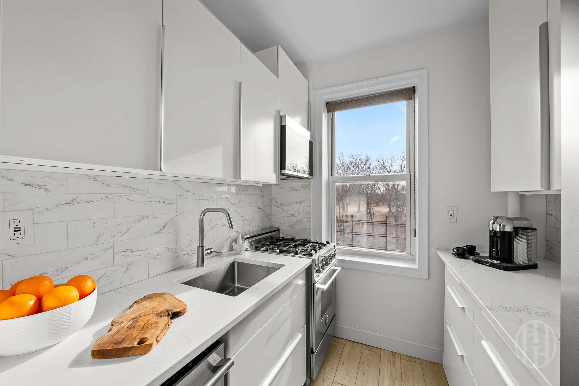 55 Eastern Parkway, Unit 6B Brooklyn, NY 11238 - Photo 6 of 9 a kitchen with stainless steel appliances granite countertop a sink and cabinets