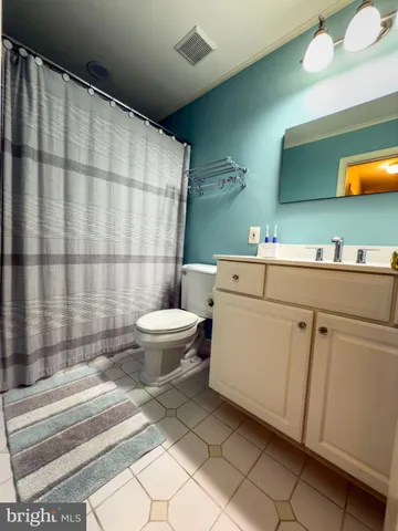 a utility room with stainless steel appliances a sink and a cabinets