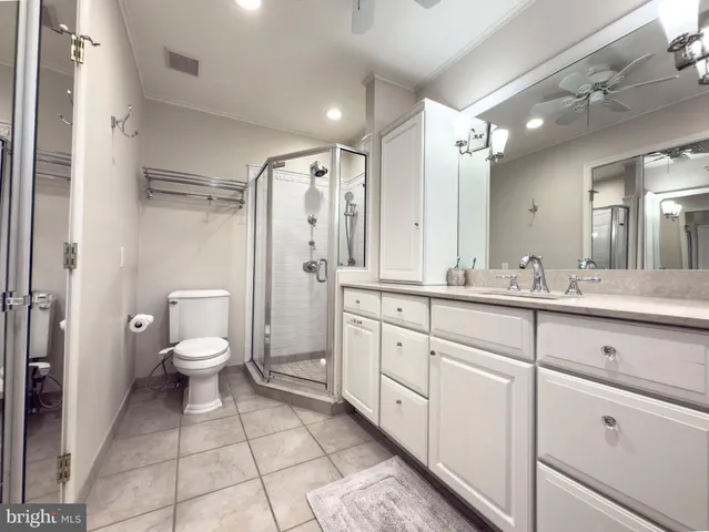 a spacious bathroom with a double vanity sink mirror and toilet