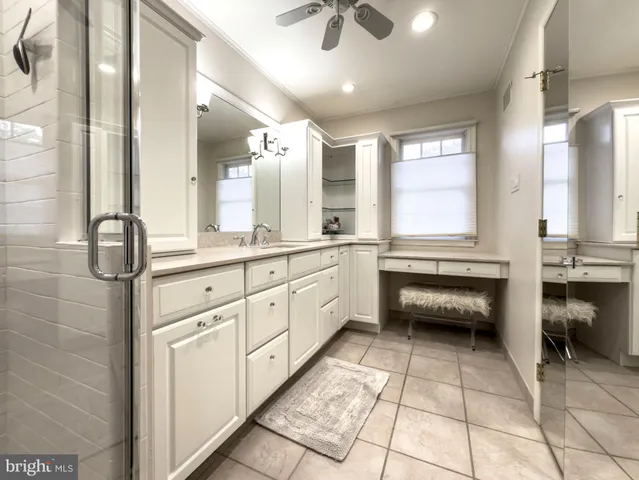 a bathroom with a granite countertop sink mirror and