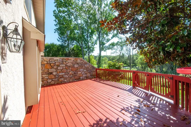 a view of balcony with wooden floor and fence