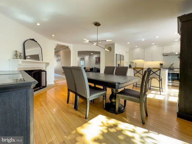 a living room with furniture a dining table and a fireplace