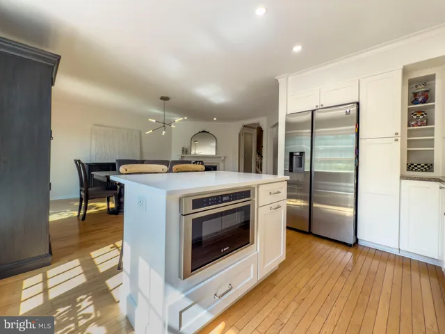 a kitchen with stainless steel appliances a stove a refrigerator and a microwave