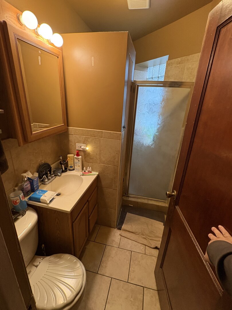 3523 North Whipple Street Chicago, IL 60618 - Photo 15 of 48 a bathroom with a sink a toilet a mirror and vanity