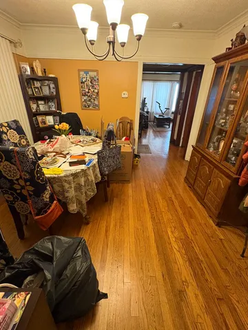 a kitchen with stainless steel appliances granite countertop a sink dishwasher and a refrigerator with wooden floor