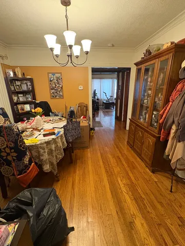 a walk in closet with wooden floor