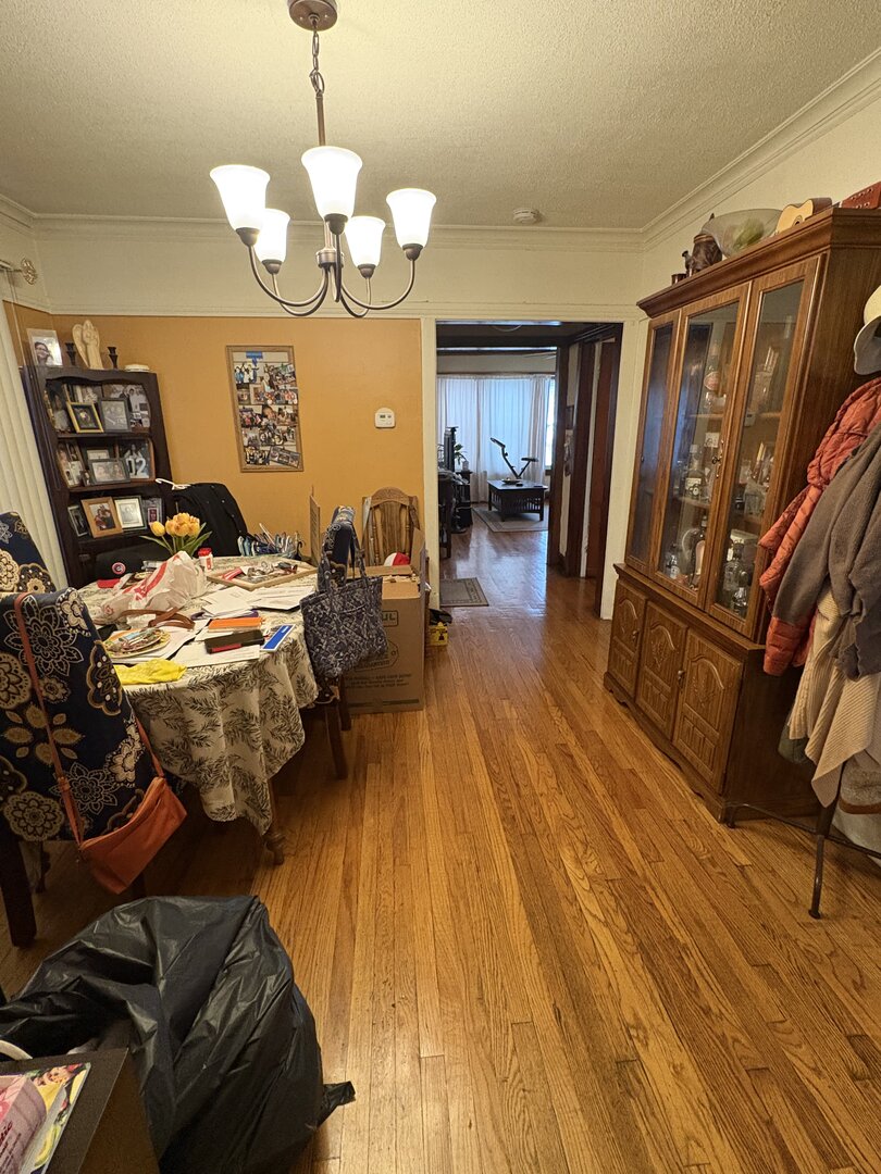3523 North Whipple Street Chicago, IL 60618 - Photo 22 of 48 a view of a dining room with furniture a chandelier and wooden floor