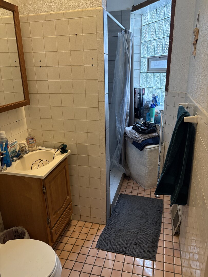 3523 North Whipple Street Chicago, IL 60618 - Photo 43 of 48 a bathroom with a sink toilet and shower
