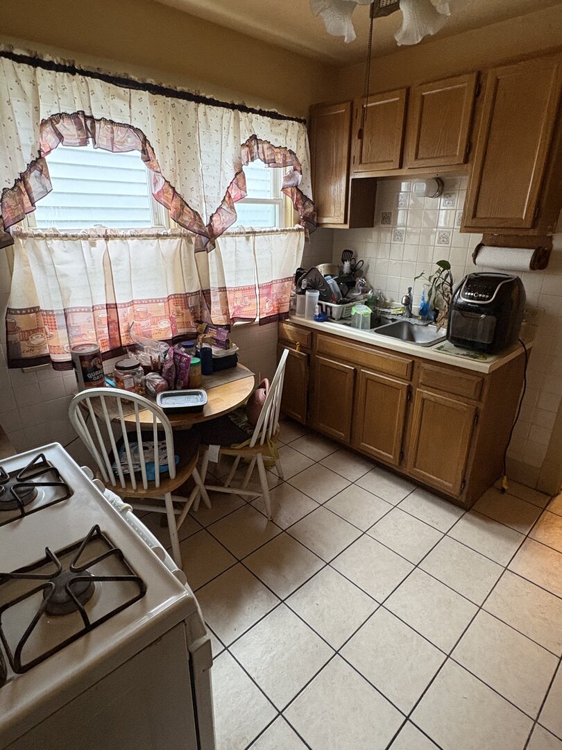 3523 North Whipple Street Chicago, IL 60618 - Photo 46 of 48 a kitchen with stainless steel appliances granite countertop a sink a stove and a refrigerator