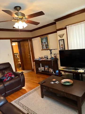 a bedroom with bed and wooden floor
