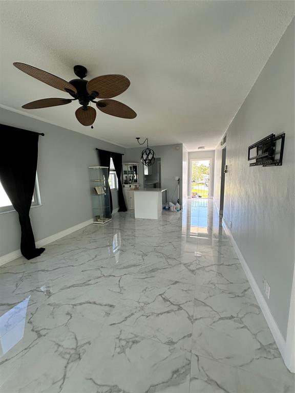 2701 East Golf Boulevard, Unit 2017 Pompano Beach, FL 33064 - Photo 13 of 26 a view of a livingroom with a furniture and a ceiling fan
