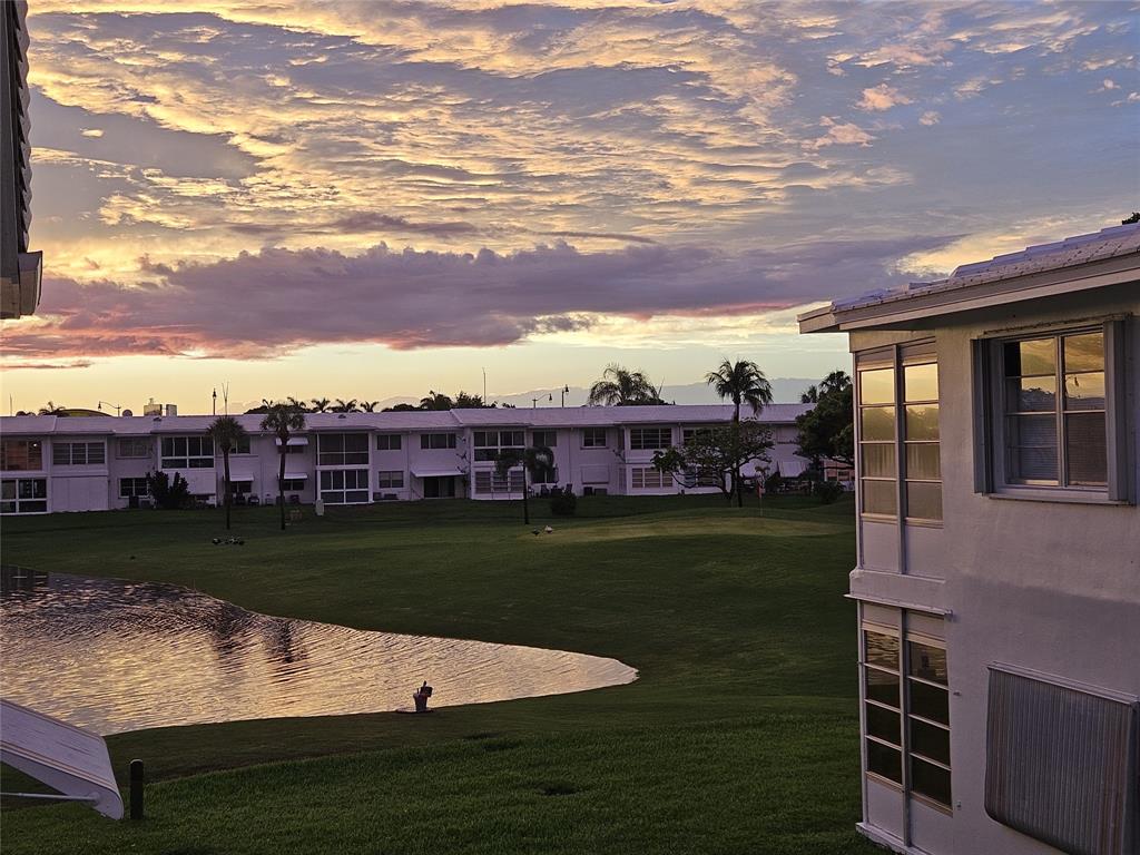 2701 East Golf Boulevard, Unit 2017 Pompano Beach, FL 33064 - Photo 14 of 26 a view of a fountain in front of a house with a big yard