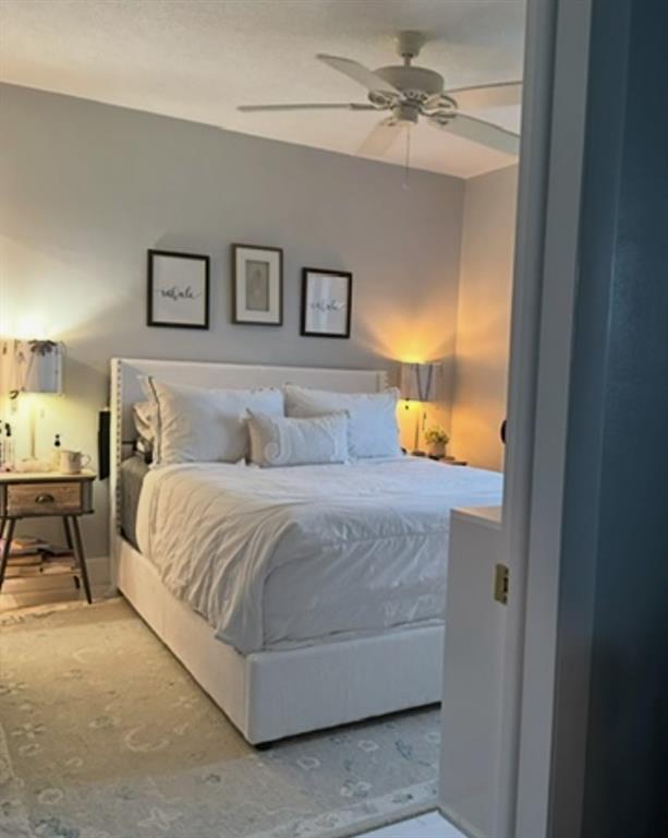 2701 East Golf Boulevard, Unit 2017 Pompano Beach, FL 33064 - Photo 2 of 26 a bedroom with a bed and a chandelier